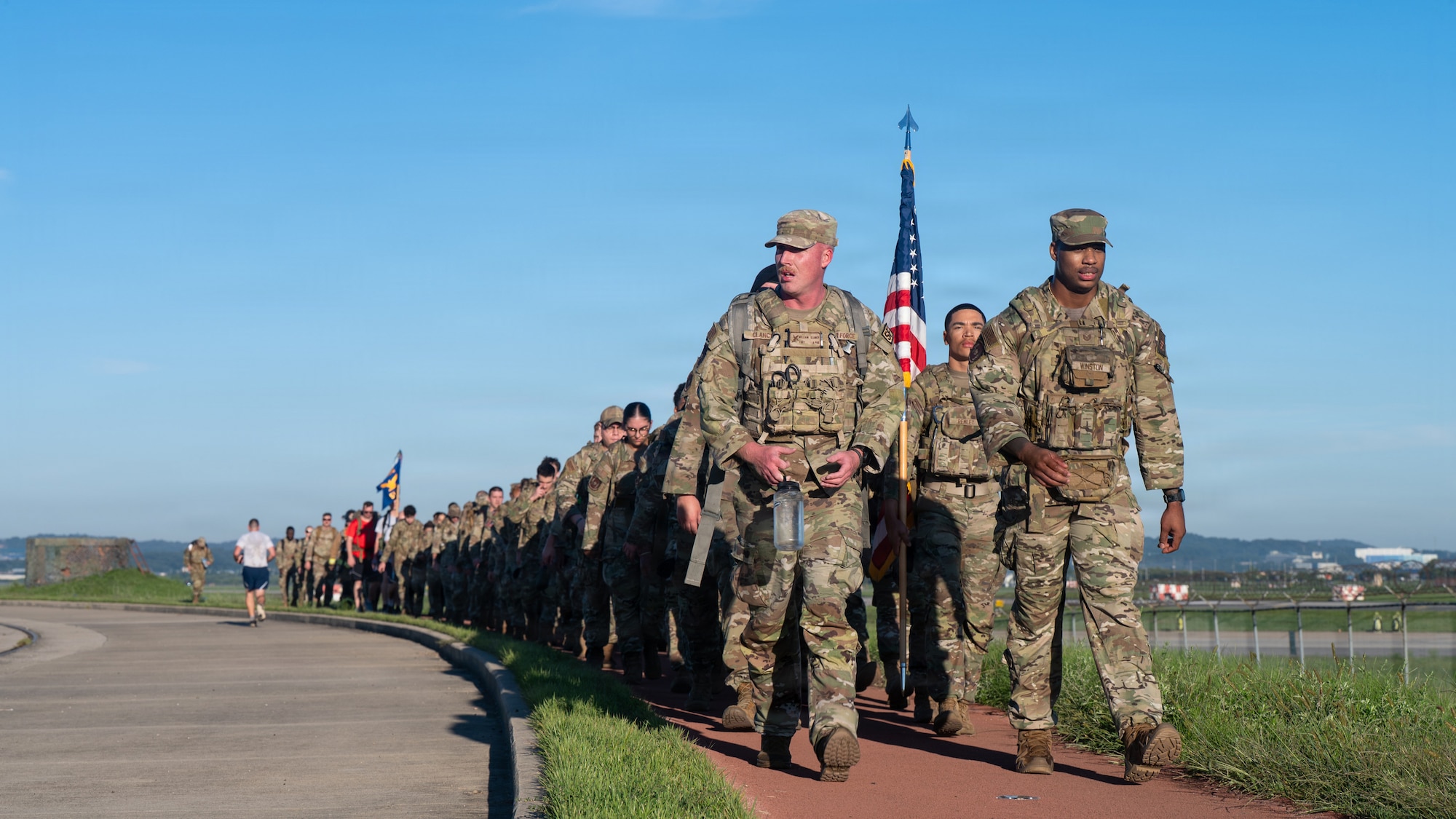U.S. service members move together during a ruck march at Osan Air Base, Republic of Korea, Sept. 11, 2026. The event honors those who lost their lives during the 9/11 terrorist attacks, remembers those who responded to the attacks and shares the resilience and fortitude of the U.S. military. (U.S. Air Force photo by Senior Airman Jessica Mun)