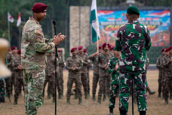 U.S. Army Lt. Col Dwayne Steppe, commander of the 1st Battalion, 501st Parachute Infantry Regiment, 2nd Mobile Brigade Combat Team (Airborne), 11th Airborne Division, applauds multinational forces at the closing ceremony of Super Garuda Shield 26 at Baturaja Combat Training Center, Indonesia, Sept. 11 2026.