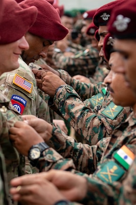 U.S. Soldiers from the 1st Battalion, 501st Parachute Infantry Regiment, 2nd Mobile Brigade Combat Team (Airborne), 11th Airborne Division and soldiers from the Indian Armed Forces conduct a wing exchange during the closing ceremony of Super Garuda Shield 26 at Baturaja Combat Training Center, Indonesia, Sept. 11 2026.