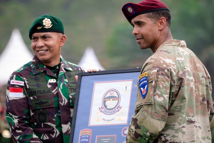 U.S. Army Lt. Col. Dwayne Steppe, commander of the 1st Battalion, 501st Parachute Infantry Regiment, 2nd Mobile Brigade Combat Team (Airborne), 11th Airborne Division, presents a token of appreciation to the Tentara Nasional Indonesia Lt. Col. Ihsan Pulungan, commander, 502nd Infantry Battalion during the closing ceremony of Super Garuda Shield 26 at Baturaja Combat Training Center, Indonesia, Sept. 11 2026.