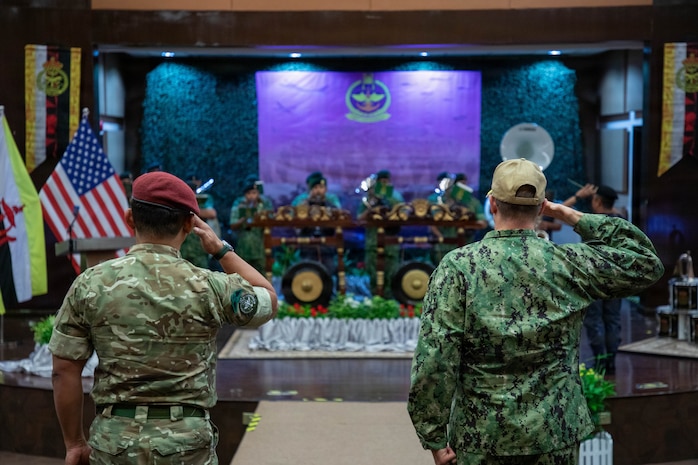 Col. Muhammad Suwardi Ariffin, left, chief of staff of Joint Force Headquarters, Royal Brunei Armed Forces, and U.S. Coast Guard Capt. Michael Ross, right, commodore of Expeditionary Cutter Squadron, render salutes during the playing of the national anthems of Brunei and the United States during the opening ceremony for exercise Cooperation Afloat Readiness and Training (CARAT) Brunei 2026, Sept. 14, 2026. CARAT Brunei 2026 is a bilateral exercise designed to enhance U.S. and partner navies’ abilities to operate together in response to shared maritime security challenges in the Indo-Pacific region. (U.S. Navy photo by Mass Communication Specialist 1st Class Dakota L. David)