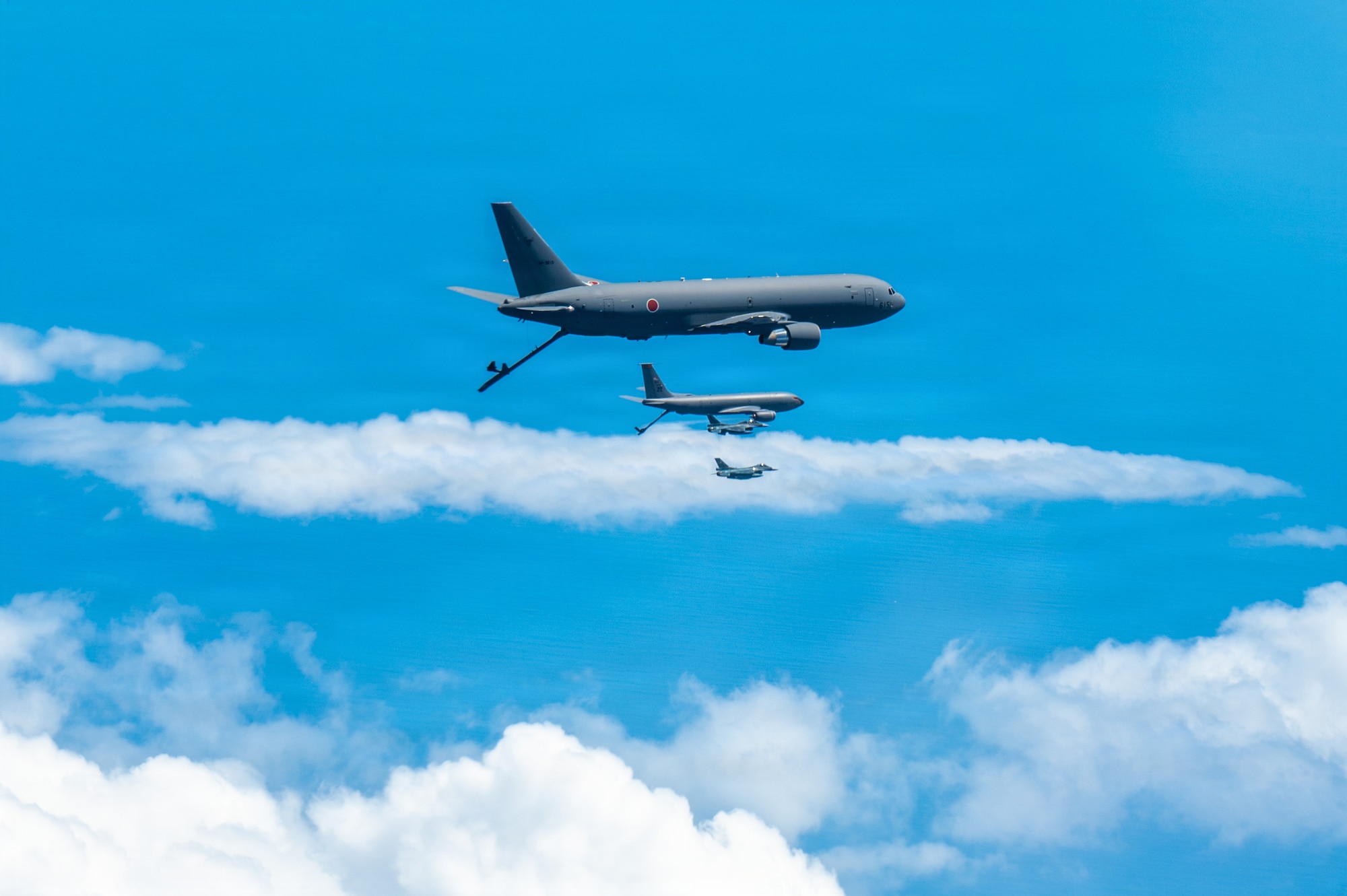 A U.S. Air Force KC-135 Stratotanker assigned to the 909th Air Refueling Squadron, and two Mitsubishi F-2s assigned to the 8th Fighter Squadron, fly in formation during bilateral training over the Pacific Ocean, Sept. 2, 2026.