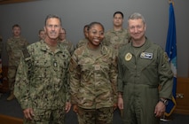 From right, Chairman of the Joint Chiefs of Staff Air Force Gen. Dan Caine, Senior Airman Alexis Goins, 48th Logistics Readiness Squadron fuels distribution operator, and Senior Enlisted Advisor to the Chairman SEAC David Isom, pose for a photo