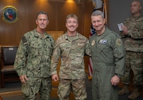 From right, Chairman of the Joint Chiefs of Staff Air Force Gen. Dan Caine, Airman 1st Class Manuel Guzman, 48th Aircraft Maintenance Squadron avionics journeyman, and Senior Enlisted Advisor to the Chairman SEAC David Isom, pose for a photo during a visit at RAF Lakenheath, England, Sept. 14, 2026.