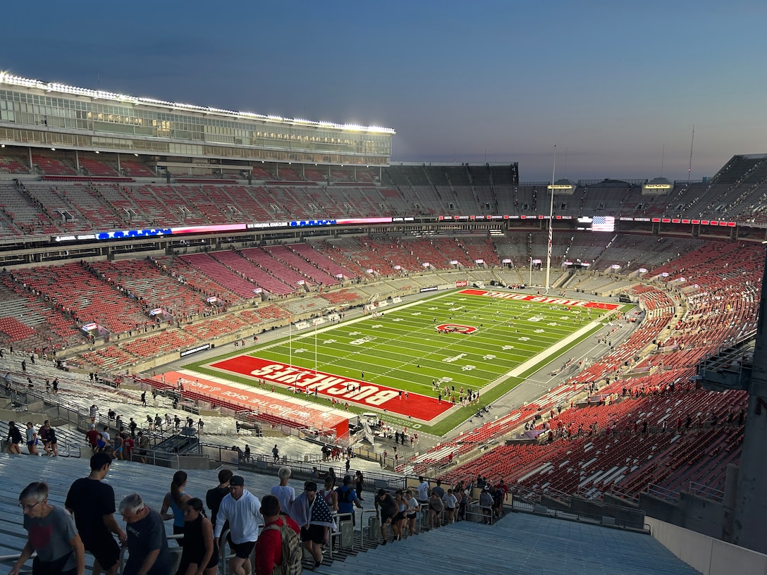 Photo of Buckeyes stadium with people walking up and down stadium steps.