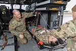 Sgt. James Gale, left, and Chief Warrant Officer 4 Josiah Zeiner, right, both with G Company, 1st Battalion, 189th Aviation Regiment, Oregon Army National Guard, practice securing the Vita hoist device to an HH-60M Black Hawk with a simulated patient, Spc. Stephanie Rider, at McNary Field Army National Guard Heliport in Salem, Oregon, Dec. 5, 2025. Photo by Maj. W. Chris Clyne.