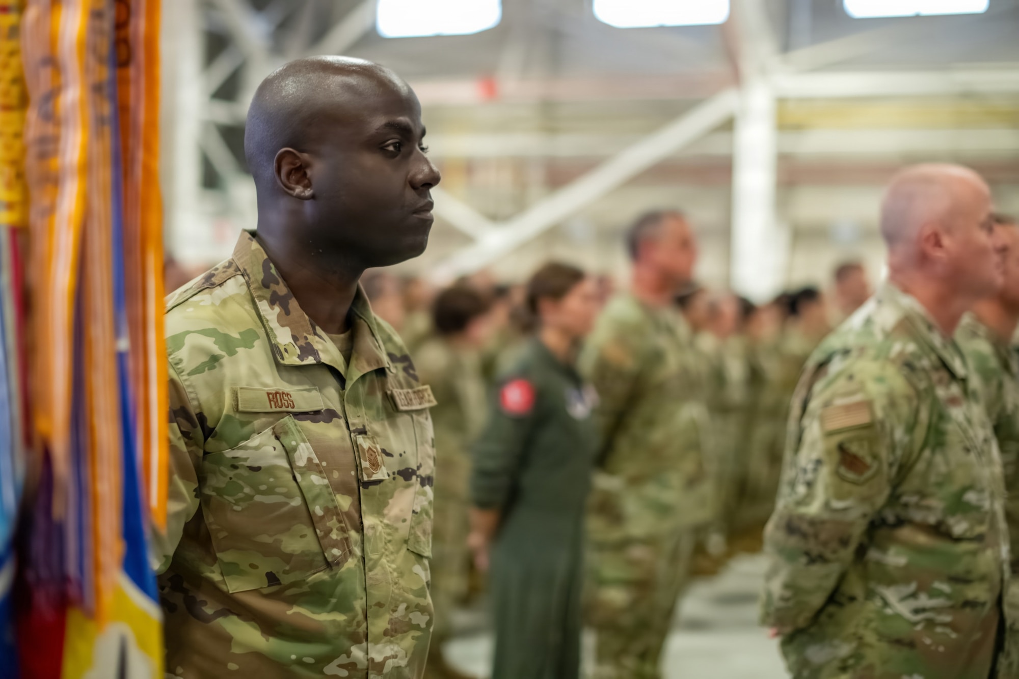 U.S. Air Force Master Sgt. Shemron Ross, 104th Logistics Readiness Squadron First Sergeant, bears the 104th Fighter Wing guidon during a ceremony at Barnes Air National Guard Base, Westfield, Mass., Sept. 13 2026. The official arrival of the F-35 to Barnes marks the culmination of a decade of effort, including work by military officials, Massachusetts state lawmakers, congressional committees, and local civic partners. The 104th's new mission to provide lethal and ready airpower to combatant commanders anytime and anywhere carries forth the heritage of the National Guard first formed in Massachusetts over 250 years ago - always ready, and by the sword. (U.S. Air National Guard photo by Airman 1st Class Elijah Harris)