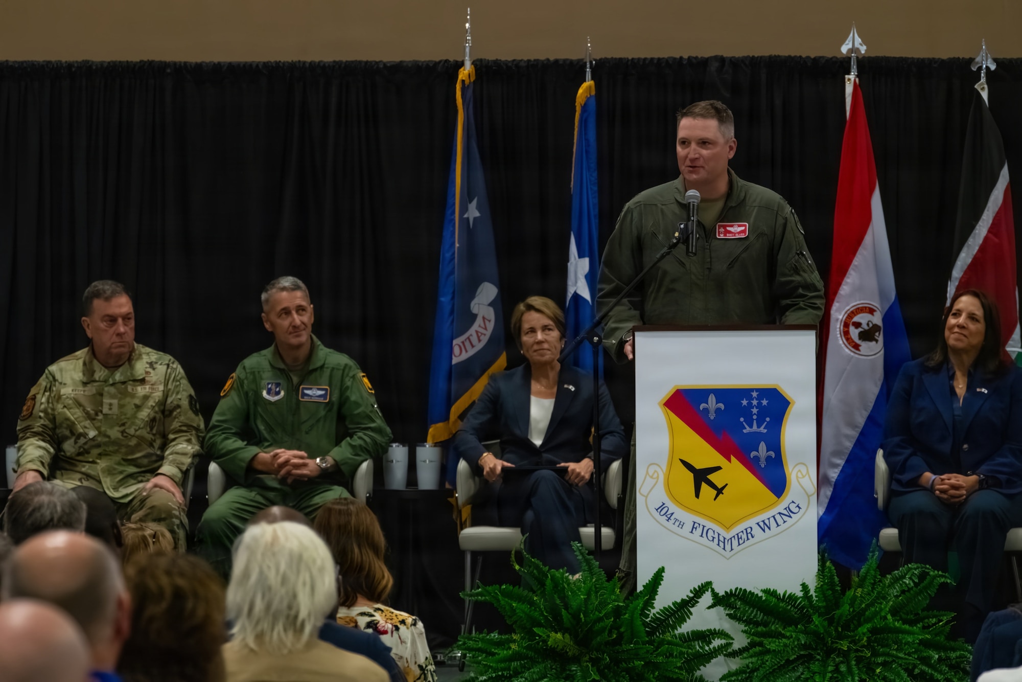 U.S. Air Force Col. Michael 'Shot' Glass, Commander of the 104th Fighter Wing, speaks to a group of servicemembers, community partners, and distinguished visitors about the significance of the arrival of the F-35A Lightning II to Barnes during a ceremony at Barnes Air National Guard Base, Westfield, Mass., Sept. 13 2026. The official arrival of the F-35 to Barnes marks the culmination of a decade of effort, including work by military officials, Massachusetts state lawmakers, congressional committees, and local civic partners. The 104th's new mission to provide lethal and ready airpower to combatant commanders anytime and anywhere carries forth the heritage of the National Guard first formed in Massachusetts over 250 years ago - always ready, and by the sword. (U.S. Air National Guard photo by Airman 1st Class Elijah Harris)