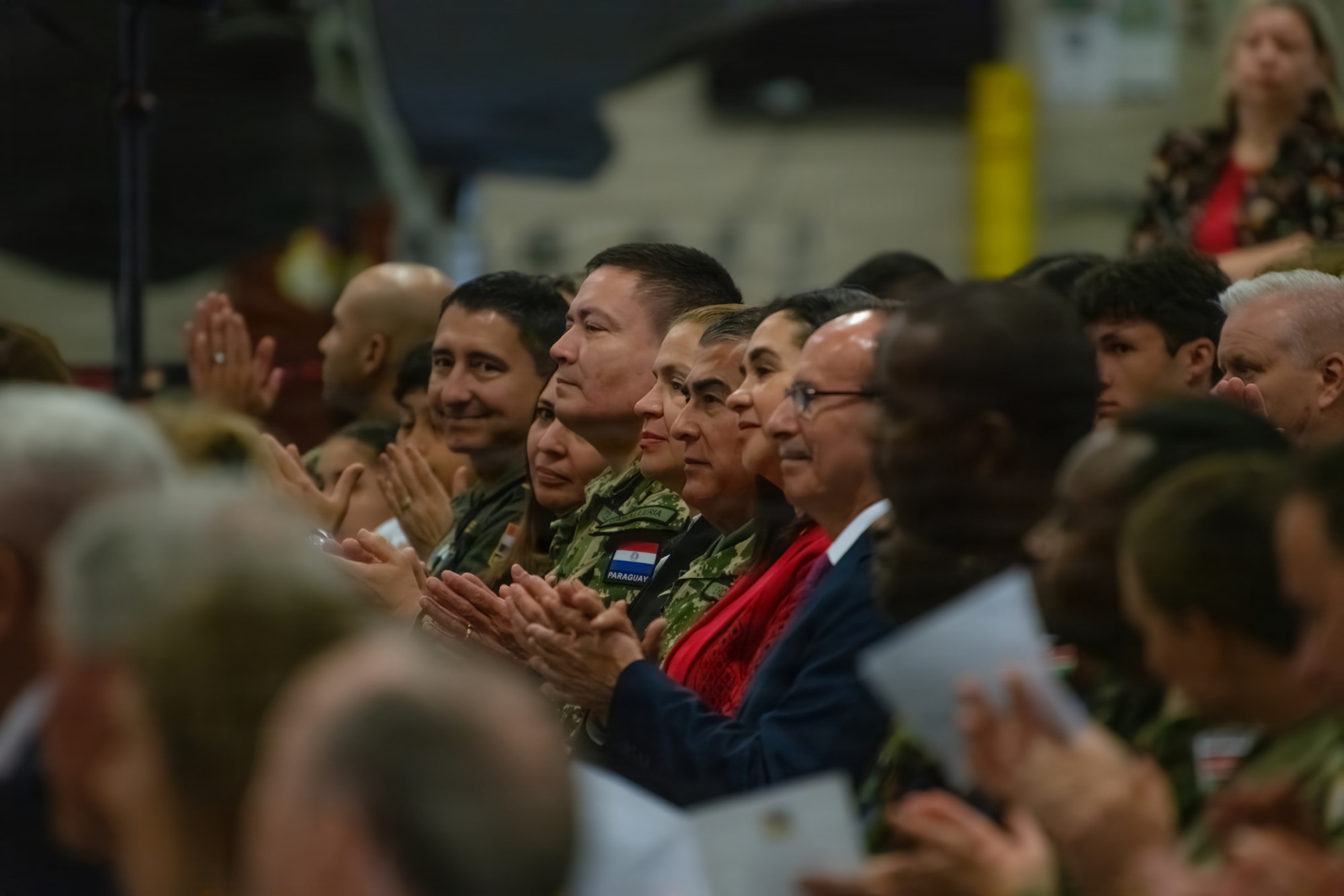 Delegates from the Paraguayan military, including Minister of Defense General Óscar Luís González Cañete, applaud after being recognized for their long-running state partnership with Massachusetts during a ceremony at Barnes Air National Guard Base, Westfield, Mass., Sept. 13 2026. The official arrival of the F-35 to Barnes marks the culmination of a decade of effort, including work by military officials, Massachusetts state lawmakers, congressional committees, and local civic partners. The 104th's new mission to provide lethal and ready airpower to combatant commanders anytime and anywhere carries forth the heritage of the National Guard first formed in Massachusetts over 250 years ago - always ready, and by the sword. (U.S. Air National Guard photo by Airman 1st Class Elijah Harris)