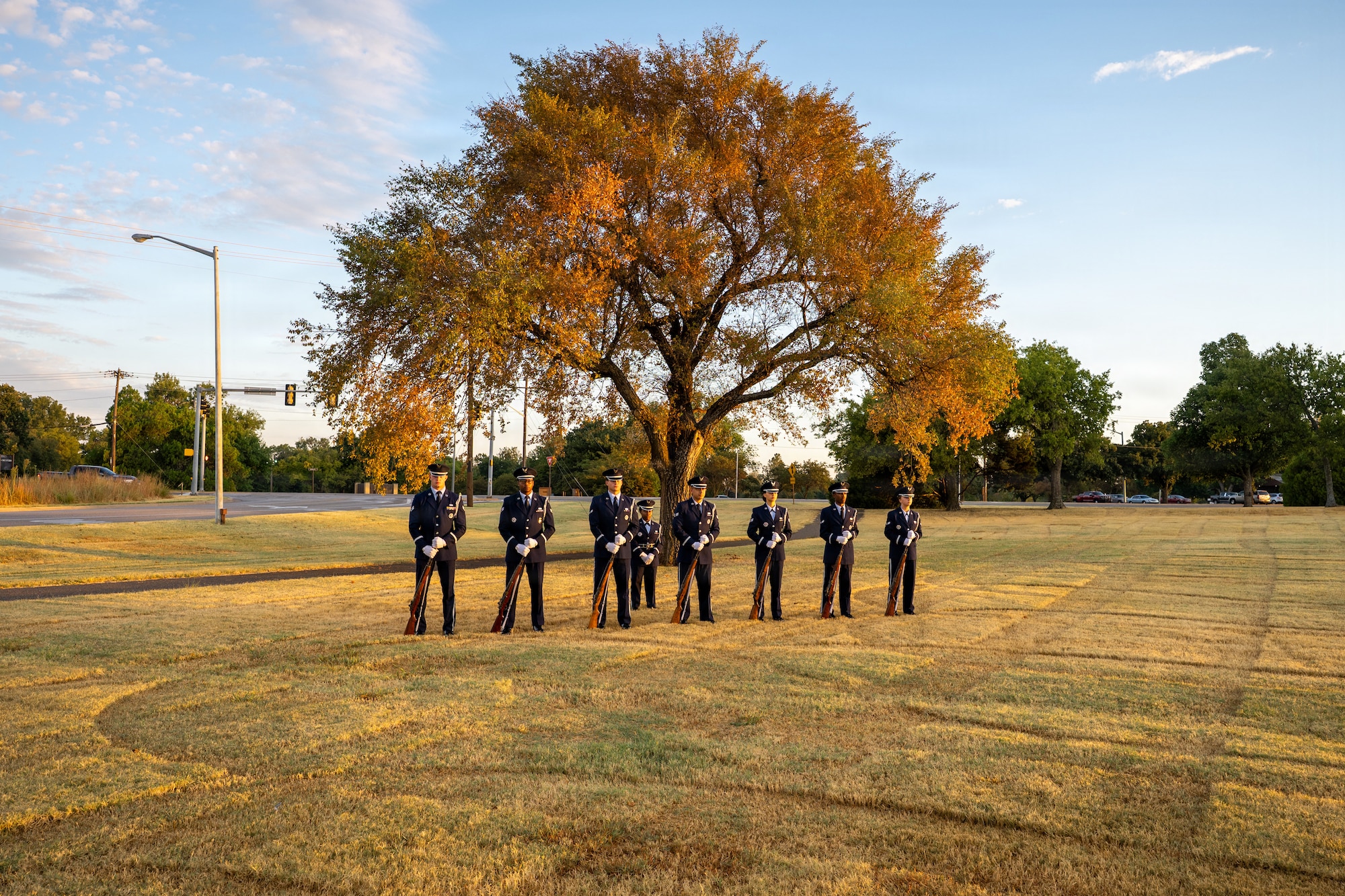 8 people standing in front of tree