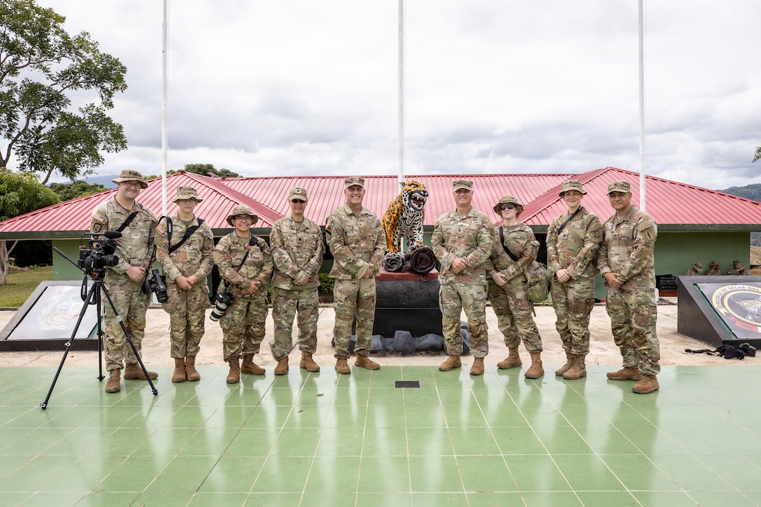 West Virginia Army National Guard members pose for a photos in front of a Jaguar statue in Peru.