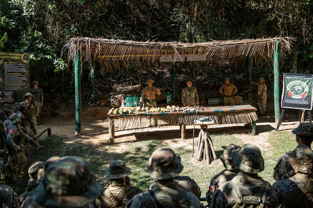 Chilean, Peruvian and U.S. soldiers gather around for instruction on Jungle Survival Tactics while in the jungle in Peru