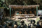 Chilean, Peruvian and U.S. soldiers gather around for instruction on Jungle Survival Tactics while in the jungle in Peru