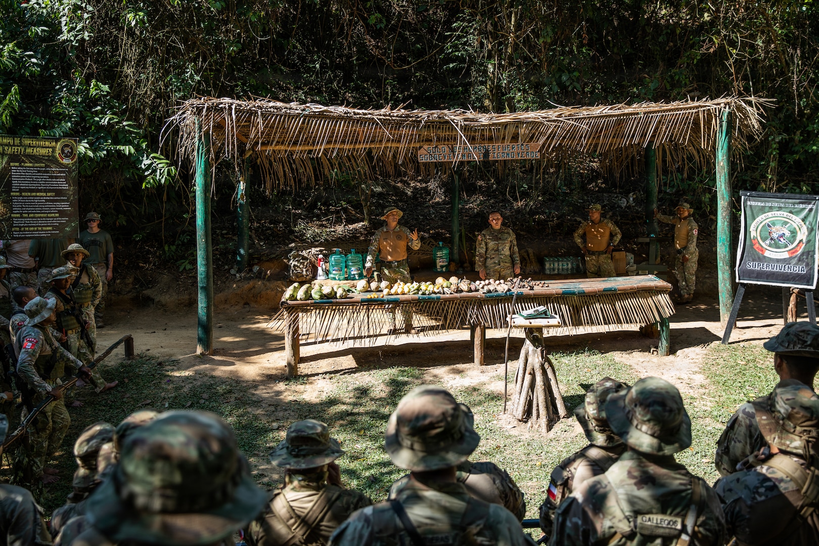 Chilean, Peruvian and U.S. soldiers gather around for instruction on Jungle Survival Tactics while in the jungle in Peru