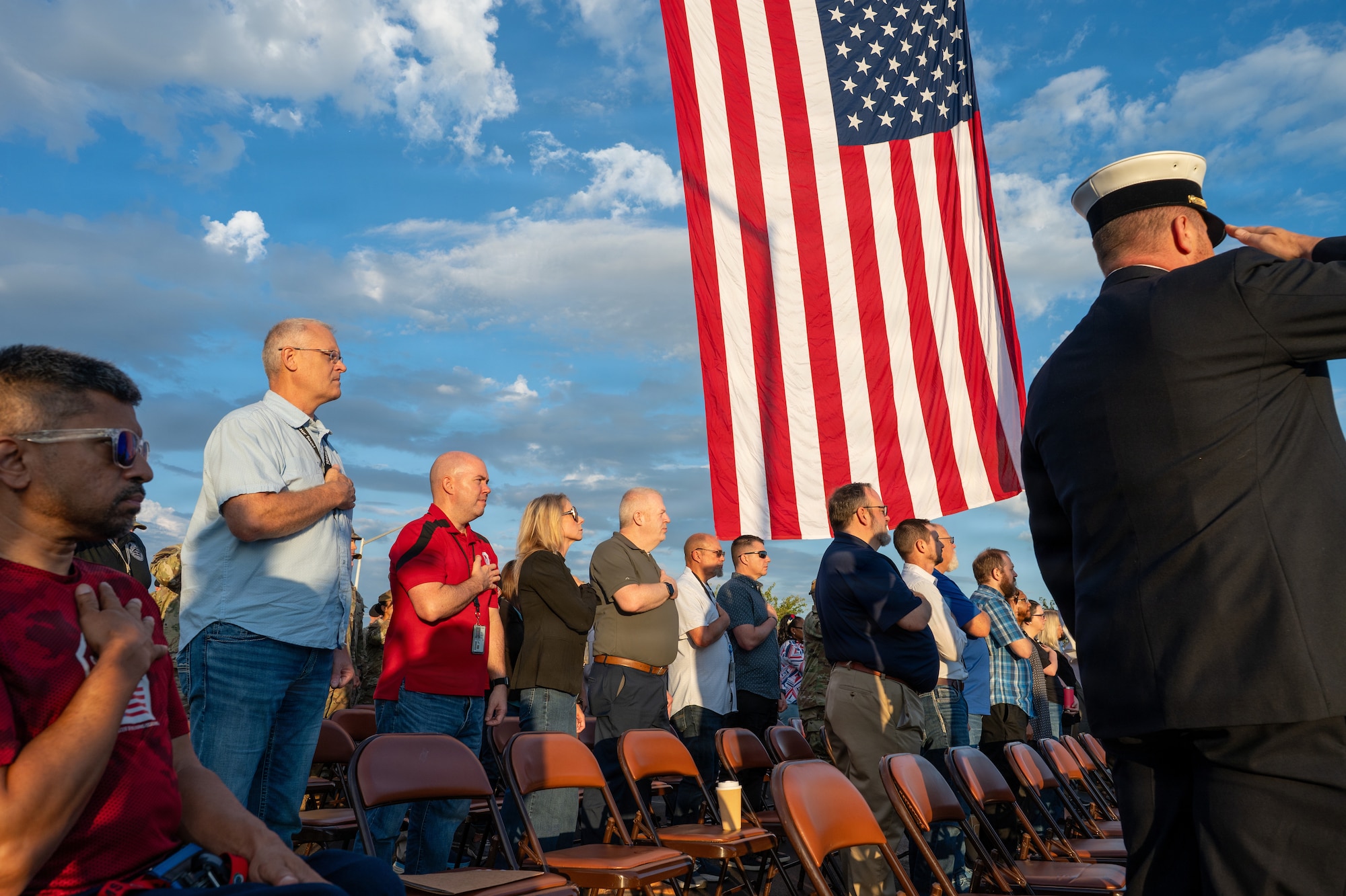 People stand during the national anthem