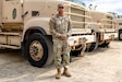 Pfc. Orlando Bibiloni posing in front of his truck while at Northern Strike, held in Camp Grayling, MI, August, 2026.