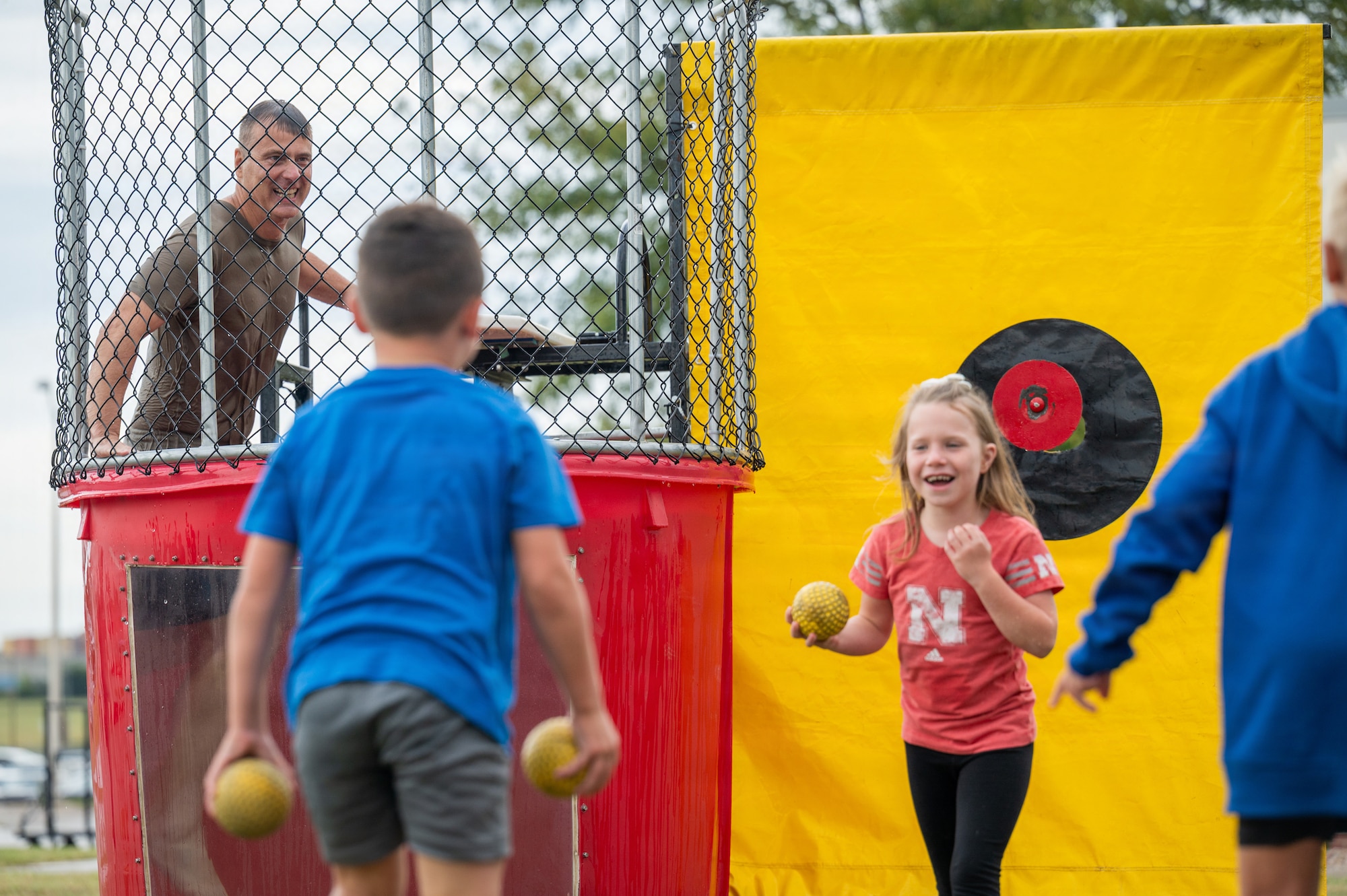 Col. Christopher Hesse, 155th Air Refueling Wing commander, climbs out of the dunk tank during Family Day, Sept. 12, 2026, at the Memorial Plaza on the Nebraska National Guard air base, Lincoln, Nebraska. Children of 155th ARW Airmen were given the first opportunity to dunk the wing commander. (U.S. Air National Guard photo by Tech. Sgt. Kevin Leahy)
