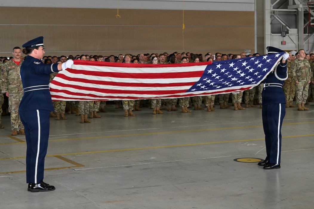 Two members of the 104th Fighter Wing Honor Guard conduct a folding of the colors during the 25th anniversary of 9/11 memorial ceremony at Barnes Air National Guard Base in Westfield, Mass., Sept. 11. The wing gathered to reflect on the lives lost and the impact the attacks had on the community.  (U.S. Air National Guard photo by Tech. Sgt. Leilani Peltz)