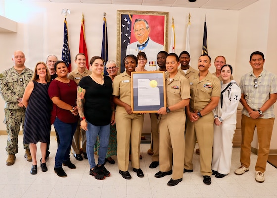Lt. Ian Mojica (center), mental health department head, poses with members of his team and the department’s Joint Commission reaccreditation certificate at Naval Hospital Twentynine Palms, Calif., Sept. 11, 2026. The mental health department earned reaccreditation with zero findings during its survey by The Joint Commission’s Behavioral Health Care and Human Services Accreditation Program. (U.S. Navy photo by Christopher Jones, NMRTC/NH Twentynine Palms public affairs officer).
