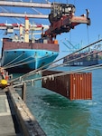 A shipping container is lifted from the water near Berth 302 at the Port of Los Angeles, Sept. 15, 2026.
