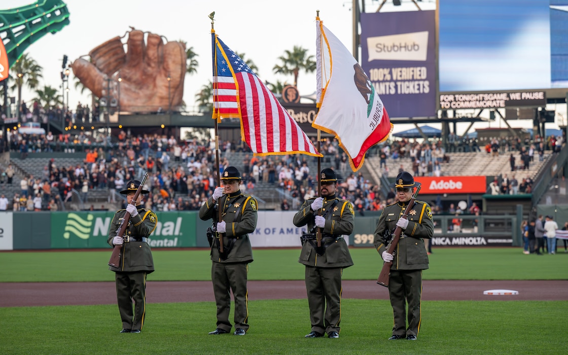 Honor Guard presents colors before baseball game.
