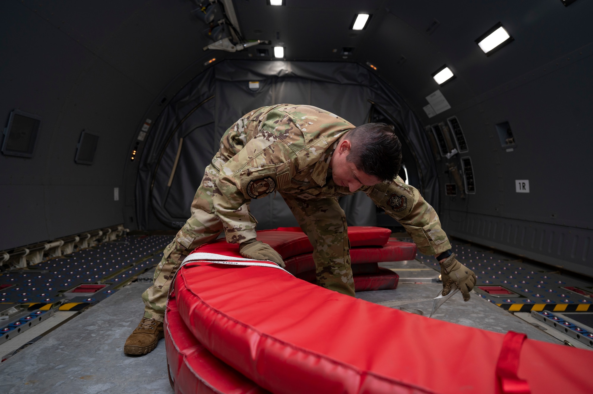 U.S. Air Force Master Sgt. Javier Garcia, 2nd Air Refueling Squadron KC-46A Pegasus aircraft boom operator instructor, secures engine covers with a ratchet strap before a routine training flight at Joint Base McGuire-Dix-Lakehurst, N.J., July 31, 2026.