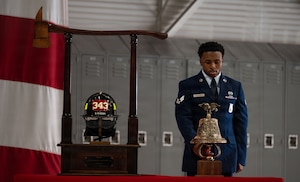 An Airman rings the ceremonial bell.