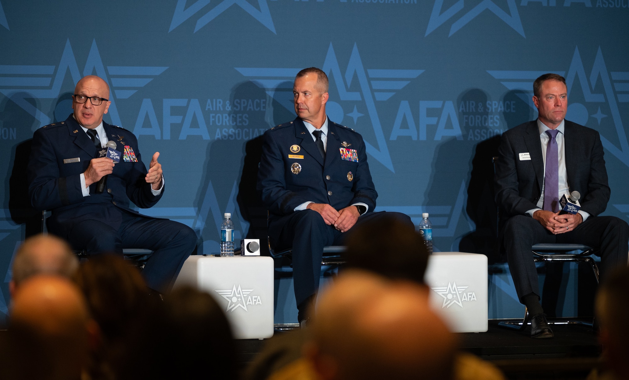 Maj. Gen. Gerald Donohue, Maj. Gen. Ty W. Neuman, and Jamie Burgess take part in a panel at the 2026 AFA Air, Space and Cyber conference in the National Harbor, Md., Sept. 14, 2026. The panel discussion focused on lessons learned from recent operations and the evolving role of long range airpower going forward. (U.S. Air Force photo by Airman 1st Class Ethan Klindt)