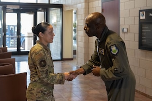 U.S. Air Force Airman 1st Class Brenda Gutierrez, 47th Flying Training Wing emergency actions controller, left, receives a coin from Maj. Gen. Travolis Simmons, commander of the 19th Air Force, at Laughlin Air Force Base, Texas, Sept. 2, 2026. Gutierrez was one of five Laughlin Airmen recognized as an outstanding performer for her contributions to the 47 FTW. (U.S. Air Force photo by Airman 1st Class Darryl Keith)